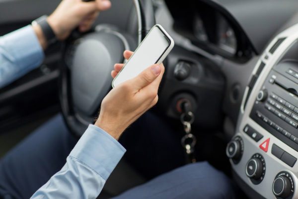 A man using a mobile phone while driving, and which is one of the image of "road rules" blog.